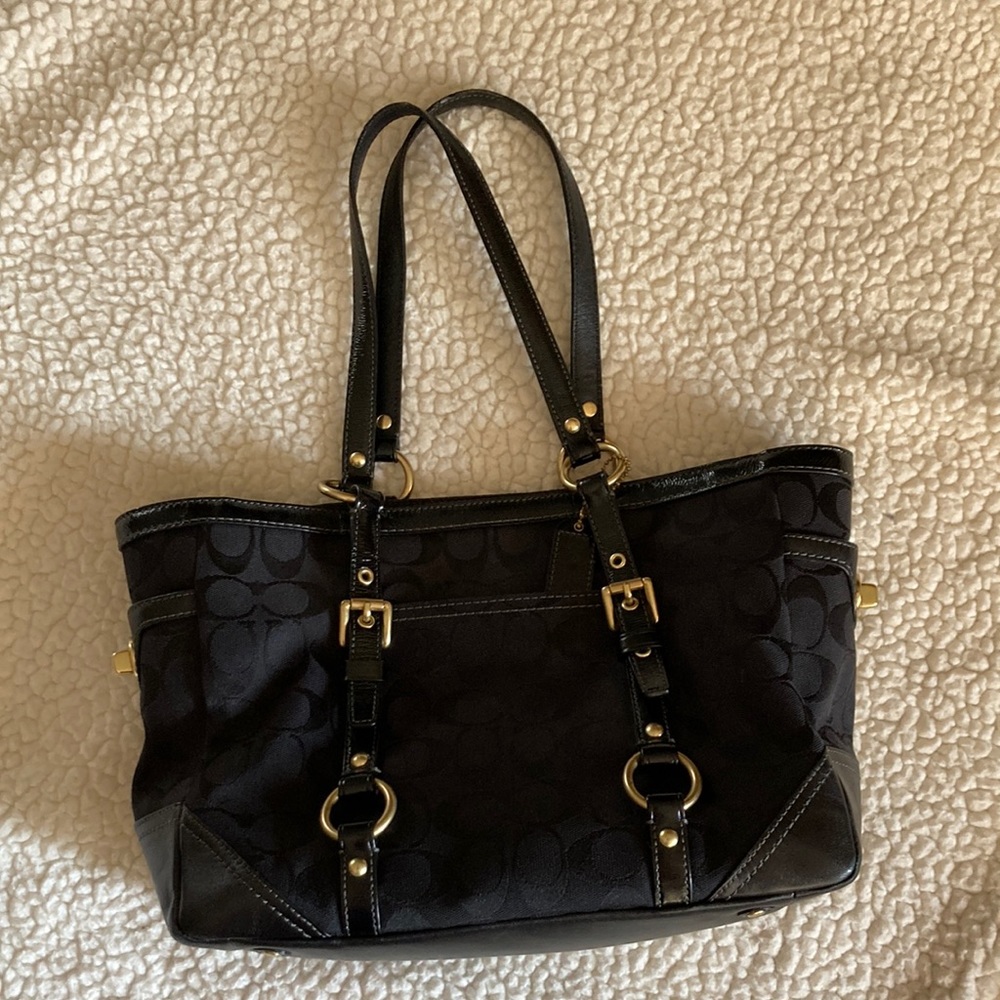 Classic black Signature Gallery Coach tote bag with brass accents.